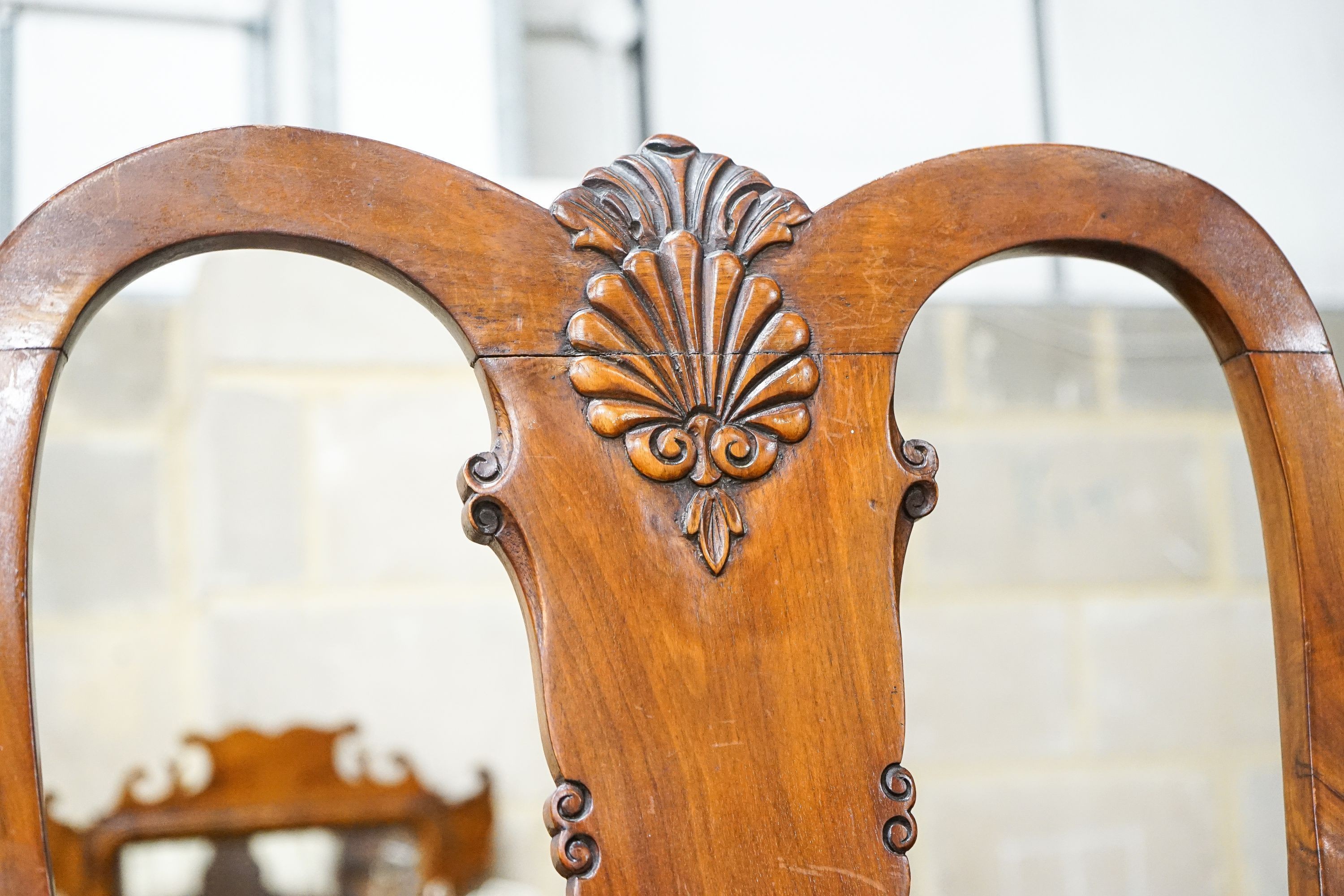 A Queen Anne style figured walnut dining suite comprising extending dining table, 200cm extended (one spare leaf), width 104cm, height 76cm, six chairs (two with arms) and a concave fronted sideboard